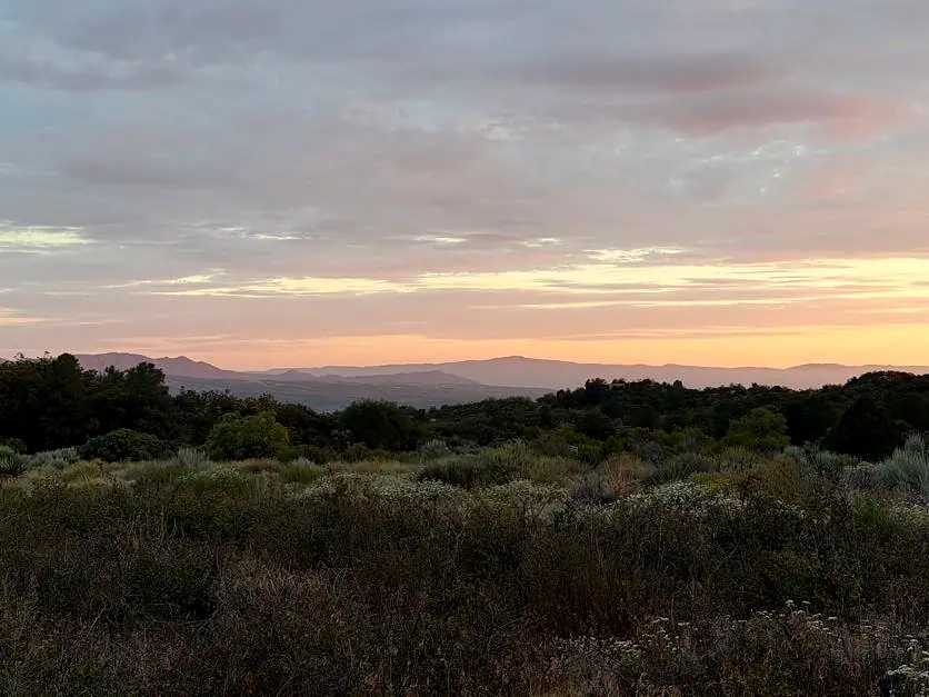Mountain layers fading into a pastel horizon